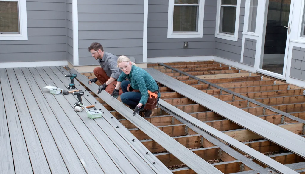 Couple expertly assembling a deck with Builders Wanaka, led by skilled Deck builders Wanaka.