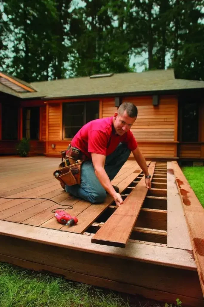 Craftsman installing timber boards, expertly done by Deck builders Wanaka at Builders Wanaka.